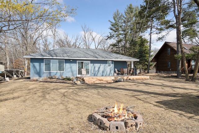 exterior space featuring an outdoor fire pit