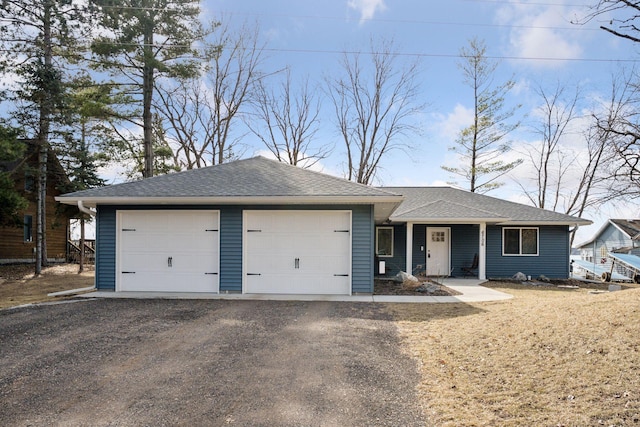 single story home with an attached garage and a shingled roof