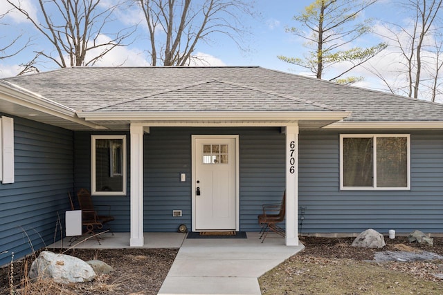 property entrance featuring a porch and roof with shingles