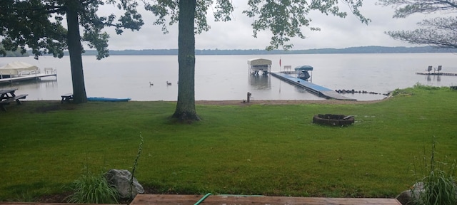 dock area featuring a yard and a water view