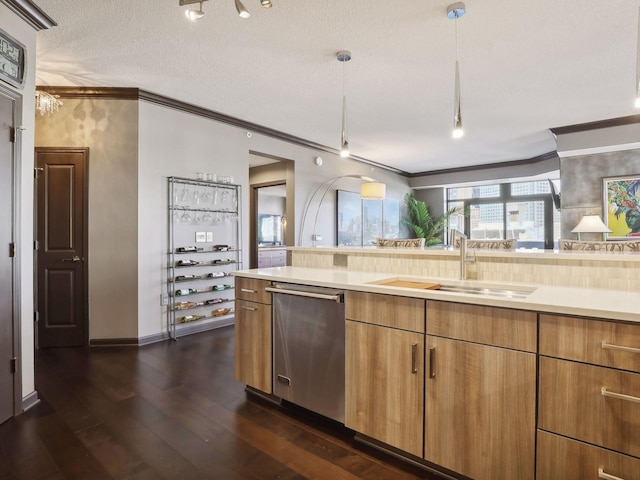 kitchen with a sink, stainless steel dishwasher, ornamental molding, and light countertops