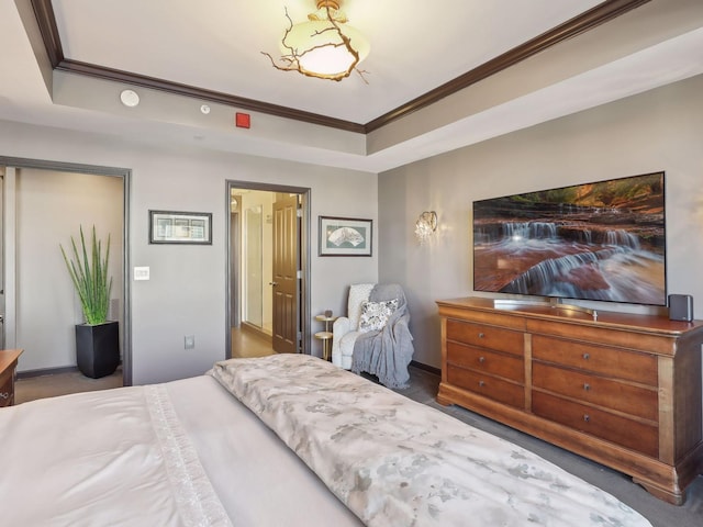 bedroom with crown molding, a raised ceiling, and baseboards