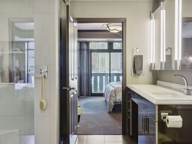 ensuite bathroom featuring vanity, tile patterned floors, and ensuite bathroom