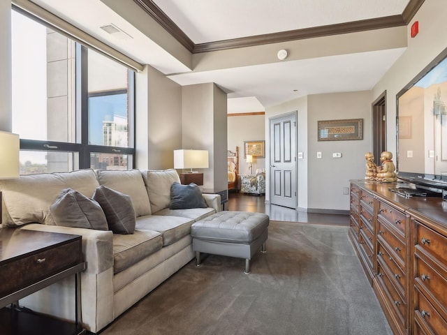 living room with visible vents, baseboards, and crown molding