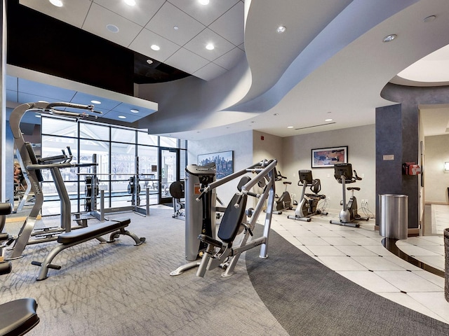 exercise room featuring recessed lighting, baseboards, and floor to ceiling windows