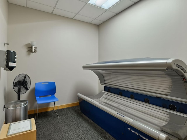 misc room with a paneled ceiling, baseboards, and carpet floors