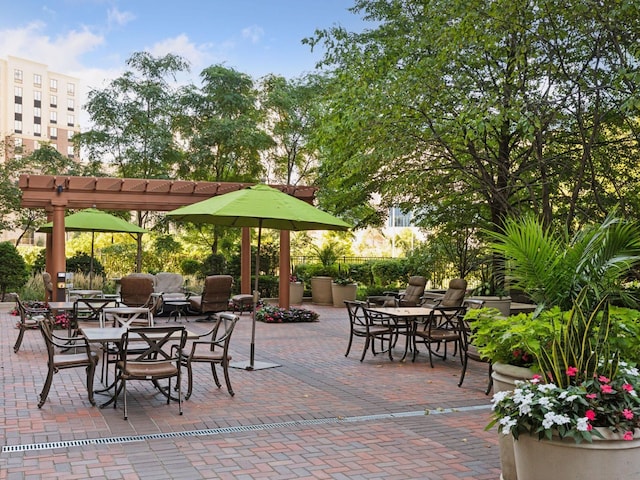 view of patio / terrace with outdoor dining space and a pergola