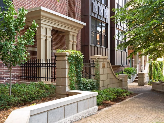 doorway to property featuring brick siding