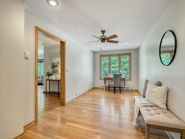 5109 Richmond Dr, Edina, MN 55436 - living area with a baseboard heating unit, light wood-style floors, a textured ceiling, a ceiling fan, and baseboards