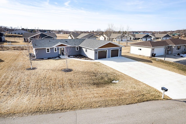 single story home featuring a residential view, an attached garage, concrete driveway, and roof with shingles