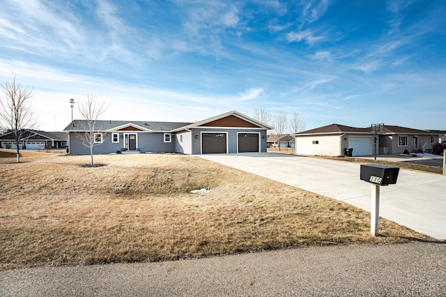 ranch-style home with an attached garage and concrete driveway