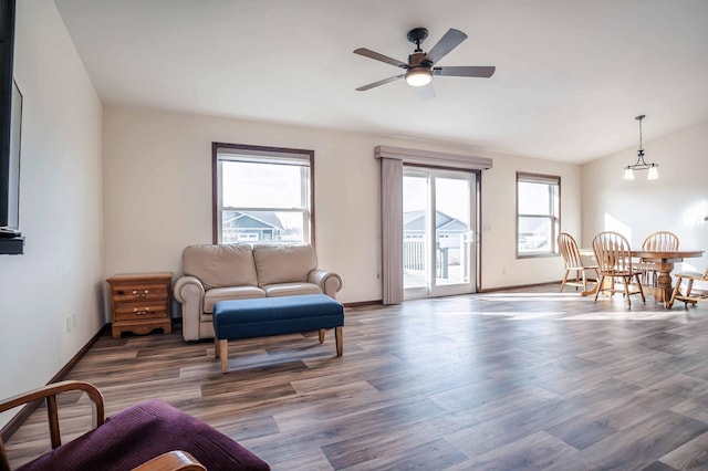 sitting room with vaulted ceiling, baseboards, ceiling fan, and wood finished floors