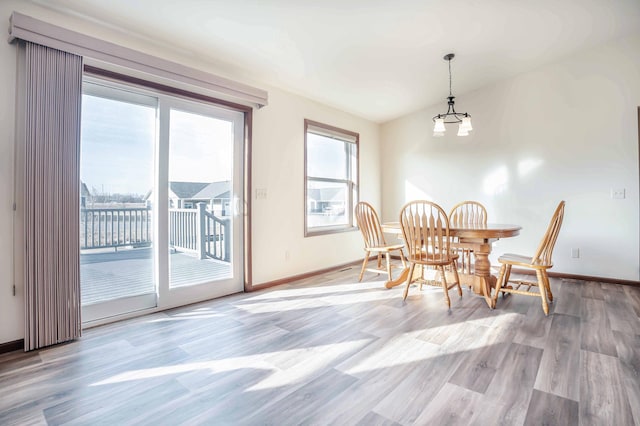 dining space featuring baseboards and wood finished floors