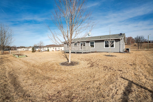 rear view of house with a wooden deck