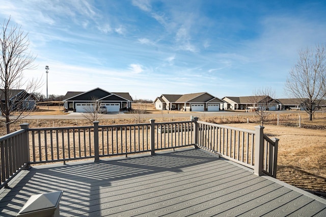 wooden deck with a garage and a residential view