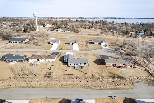 birds eye view of property with a water view and a residential view