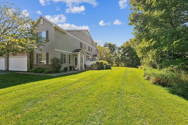 view of property exterior featuring a yard, driveway, brick siding, and a garage