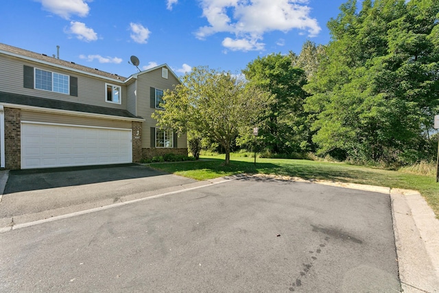 view of front facade with aphalt driveway, brick siding, an attached garage, and a front lawn