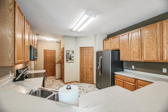 kitchen featuring a textured ceiling, light countertops, stainless steel fridge with ice dispenser, and electric range oven