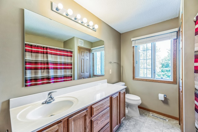 full bath with visible vents, baseboards, toilet, vanity, and a textured ceiling