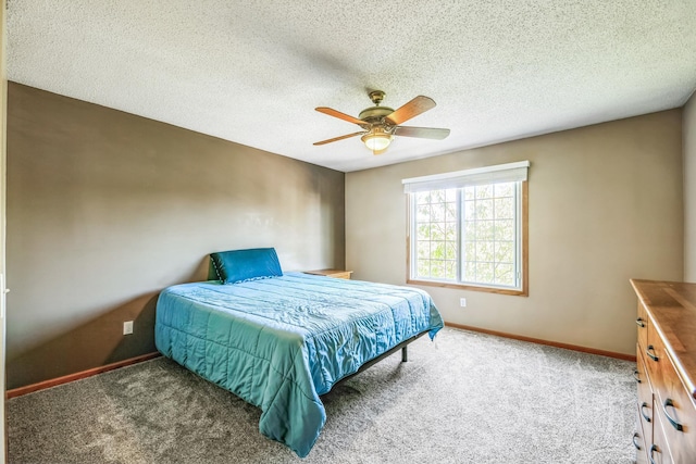 carpeted bedroom featuring baseboards, a textured ceiling, and a ceiling fan