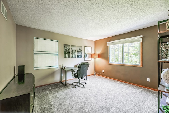 carpeted home office with visible vents, baseboards, and a textured ceiling