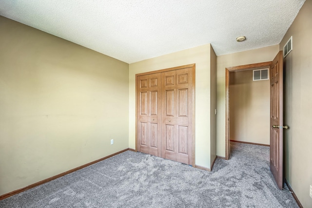 unfurnished bedroom featuring carpet, visible vents, a closet, and baseboards