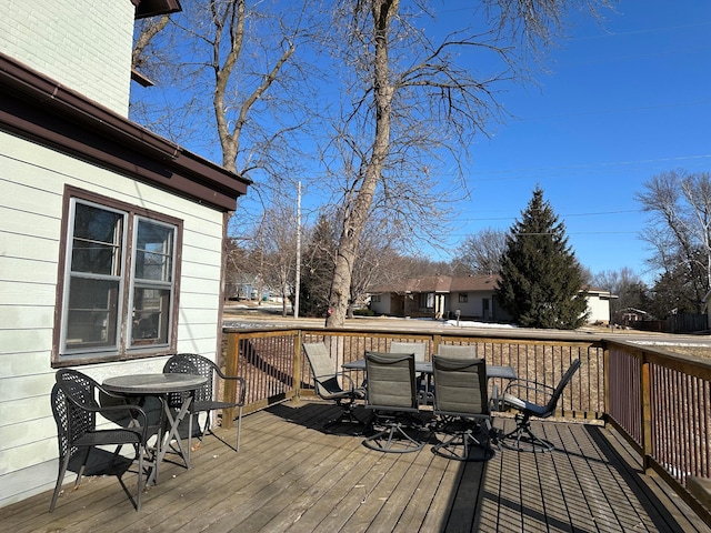 wooden deck featuring outdoor dining area