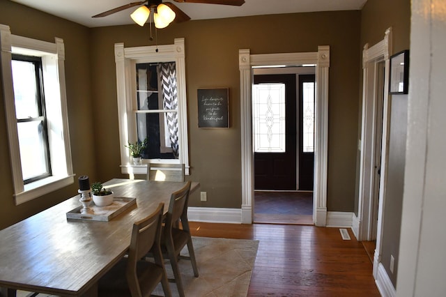 dining area with baseboards, ceiling fan, and hardwood / wood-style floors