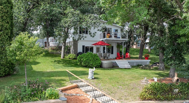 back of property featuring a yard and a wooden deck