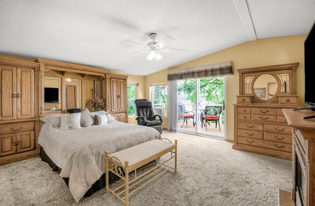 bedroom featuring a ceiling fan, lofted ceiling, a textured ceiling, access to outside, and light colored carpet