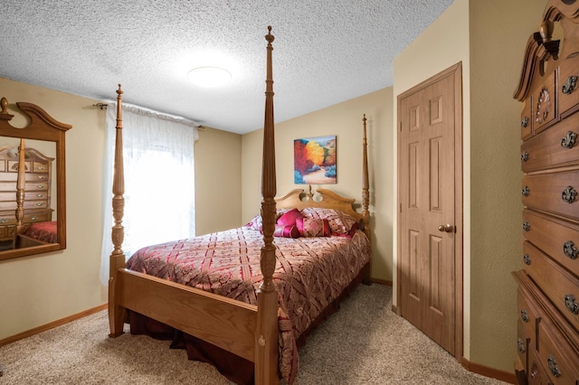 carpeted bedroom featuring a textured ceiling and baseboards