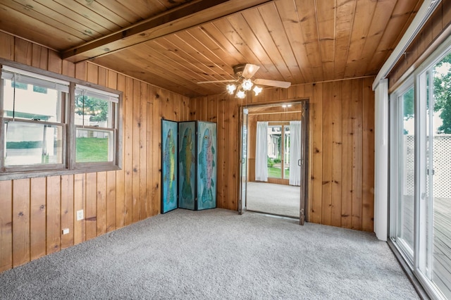 unfurnished room featuring carpet flooring, plenty of natural light, wooden ceiling, and ceiling fan