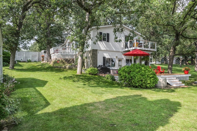 view of yard with a deck and fence