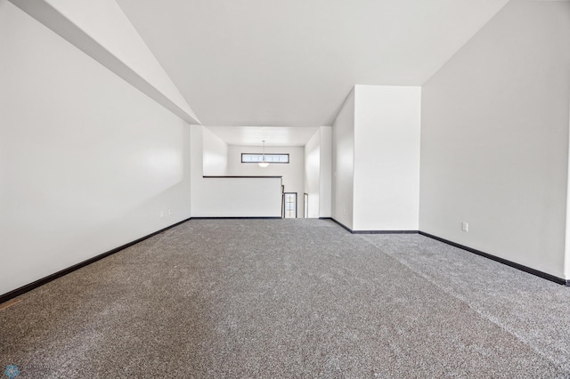 carpeted spare room with an inviting chandelier and baseboards