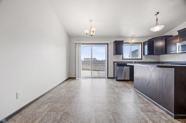 kitchen featuring a sink, appliances with stainless steel finishes, baseboards, a chandelier, and hanging light fixtures