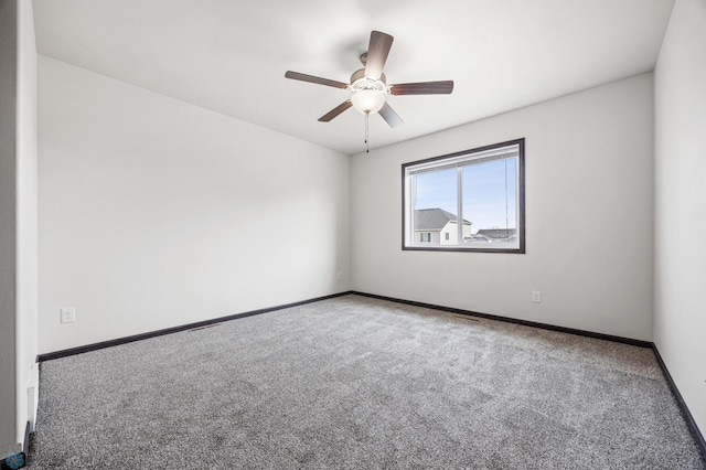 empty room with a ceiling fan, baseboards, and carpet floors