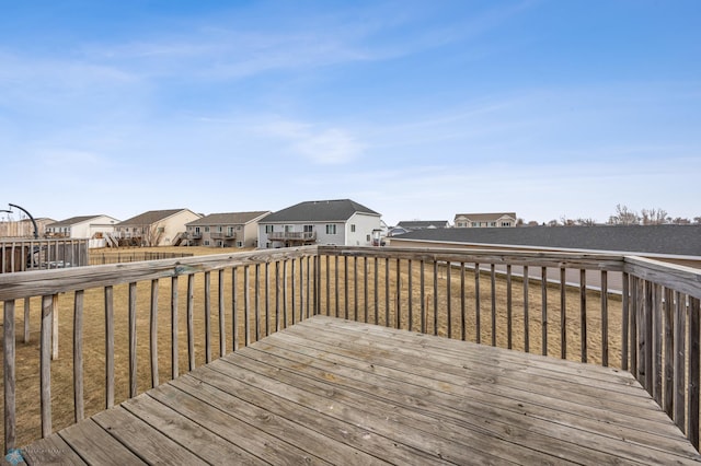 wooden terrace featuring a yard and a residential view