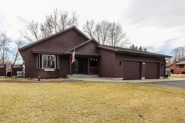 view of front of property featuring driveway, a front lawn, and a garage