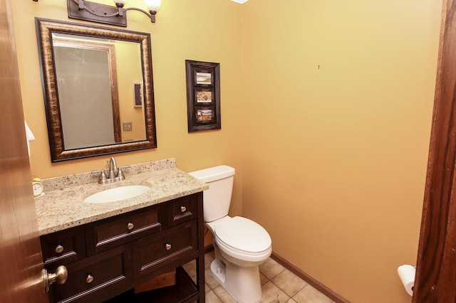 bathroom featuring tile patterned flooring, toilet, vanity, and baseboards