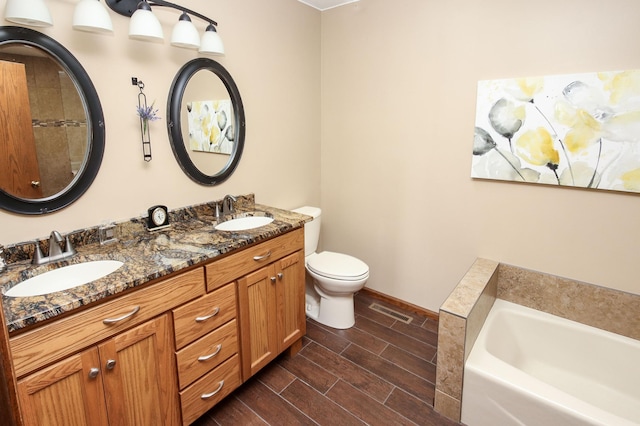 full bathroom featuring a bath, toilet, wood finish floors, and a sink