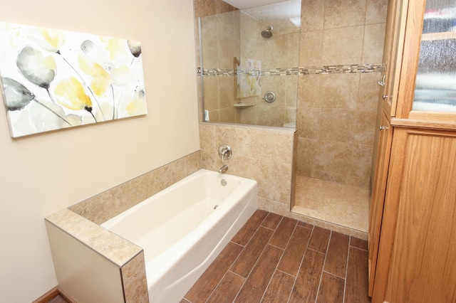 full bath with a garden tub, walk in shower, and wood tiled floor