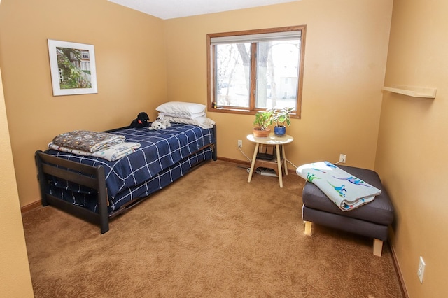 carpeted bedroom featuring baseboards