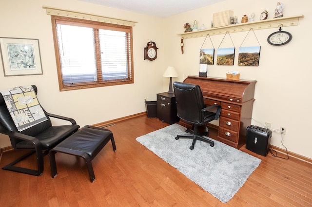 home office featuring wood finished floors and baseboards