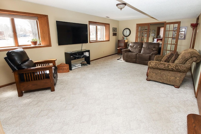 carpeted living area with baseboards