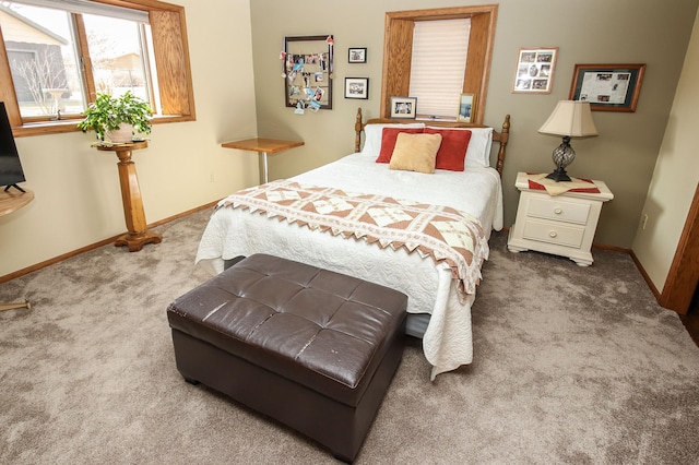 carpeted bedroom featuring baseboards