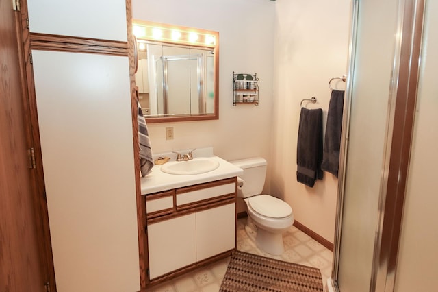 bathroom featuring vanity, baseboards, a shower stall, tile patterned floors, and toilet