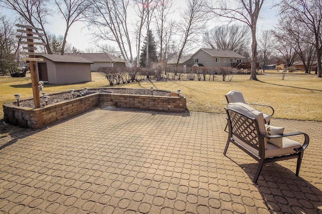 view of patio / terrace with an outbuilding and a storage shed