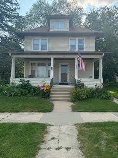 traditional style home featuring covered porch