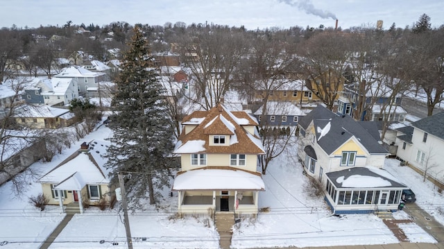 snowy aerial view featuring a residential view